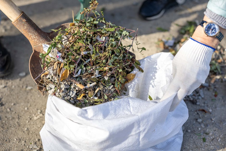 A large pile of demolished building debris is situated in an outdoor area, consisting of broken concrete slabs, bricks, and fragments of construction materials. The rubble is irregularly stacked, with